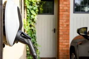 A home EV charger on the left with a small view of the vehicle being charged on the right